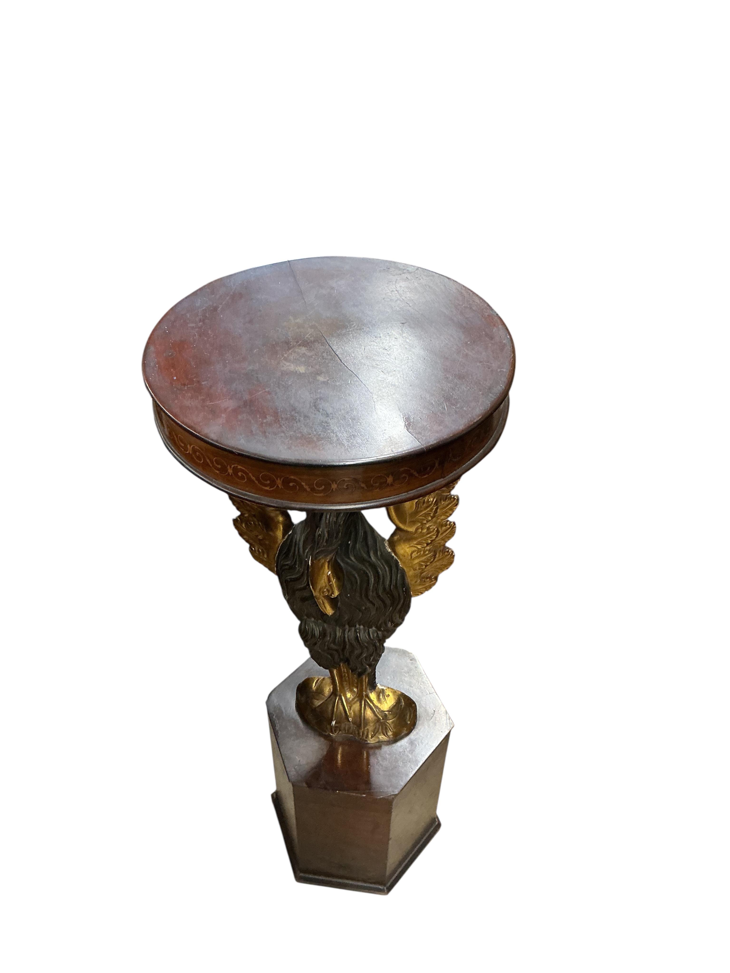 An Empire style carved wood phoenix occasional table on hexagonal plinth, height 99cm